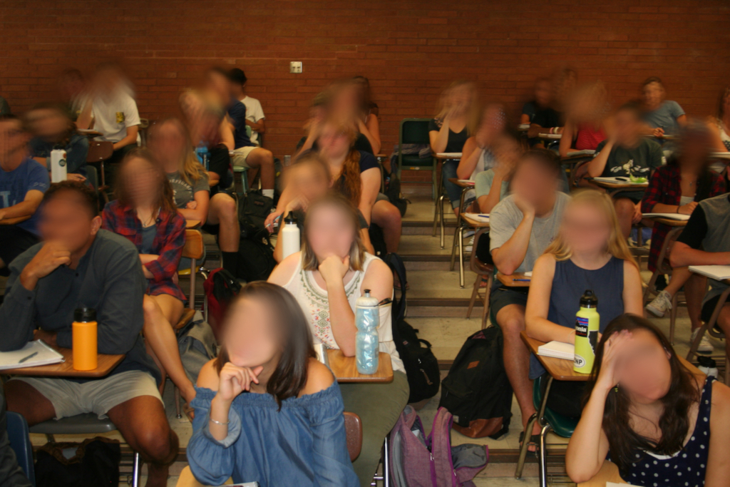 Students sitting in their seats in a classroom.